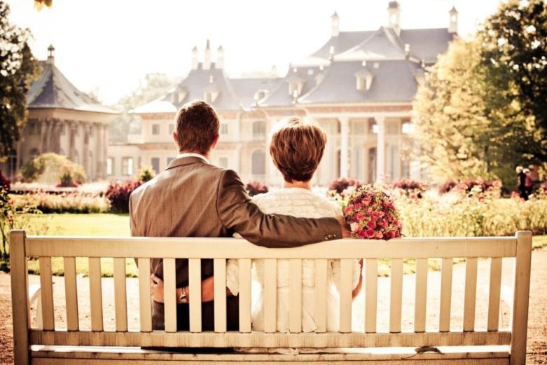 Two people sitting on a bench